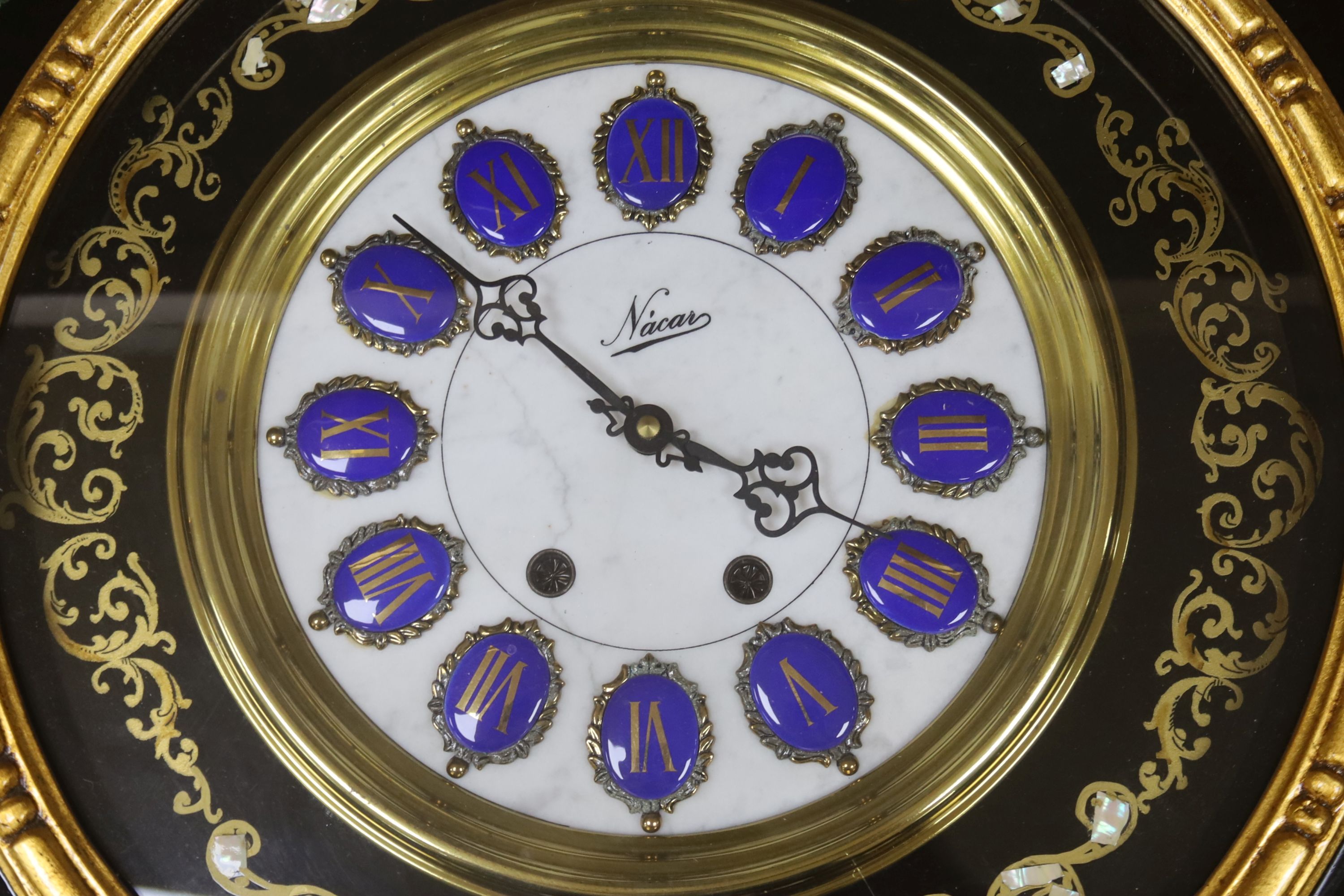 A floral painted clock, length 63cm, quartz movement